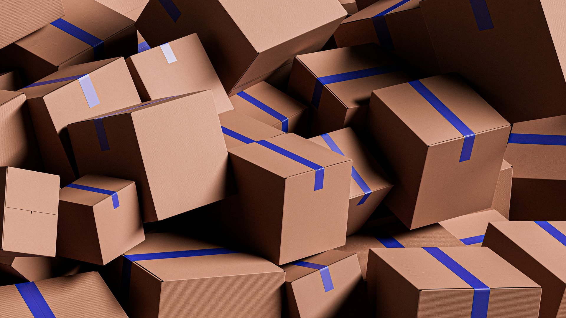 Cardboard shipping boxes sealed with blue tape, piled together